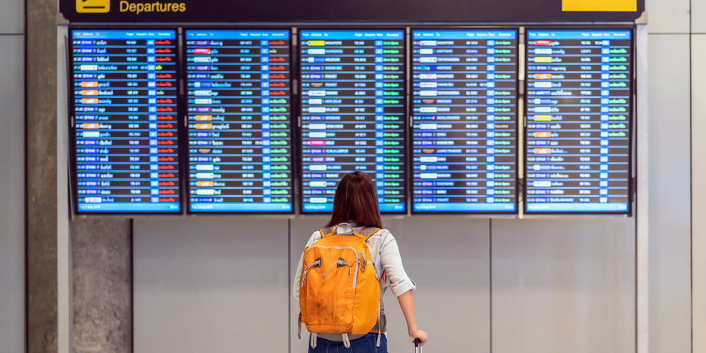 A traveller checking flights at an airport. Courtesy: Today.com